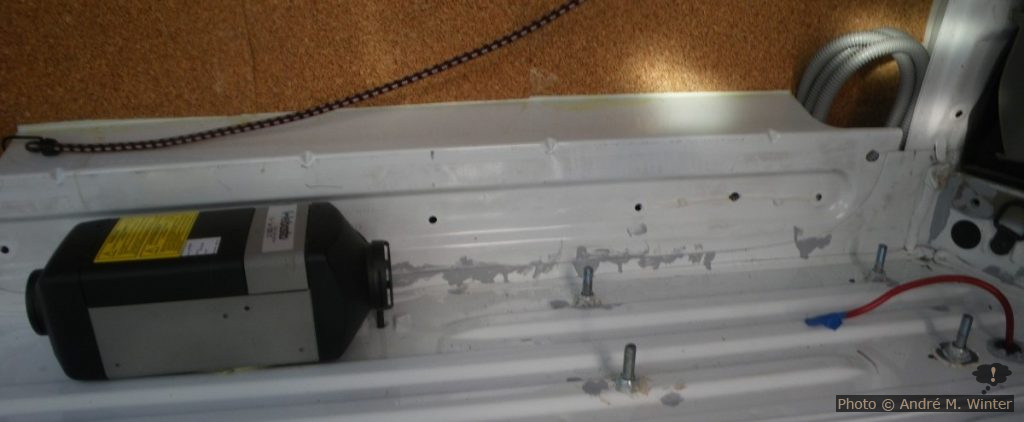 Die Bolzen rechts halten die Zweitbatterie in einem Hohlraum unter der Karrosserie. Der Kabelbaum der Standheizung ist hier noch nicht angeschlossen, geht aber hinten gegen die Aussenwand auf der Höhe der Aufschrift «Webasto» hinaus.