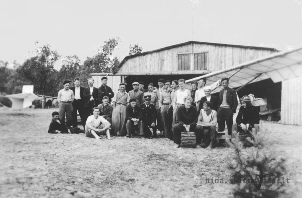 Gregor und andere vor Flieger und dem Hangar auf Nida